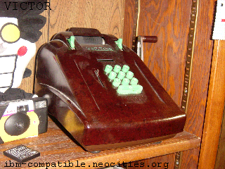 A large brown adding machine with bright green buttons.